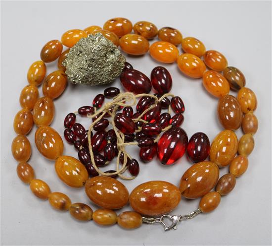 A pyrite geode and two simulated amber necklaces. A pyrite geode and two simulated amber necklaces.
