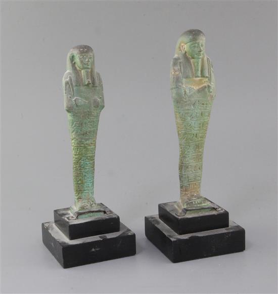 Two Egyptian green glazed composition Shabti, late period, 26th-30th dynasty, circa 664-332 B.C., 18.5 and 19cm excluding ebonised wood Two Egyptian green glazed composition Shabti, late period, 26th-30th dynasty, circa 664-332 B.C., 18.5 and 19cm excluding ebonised wood