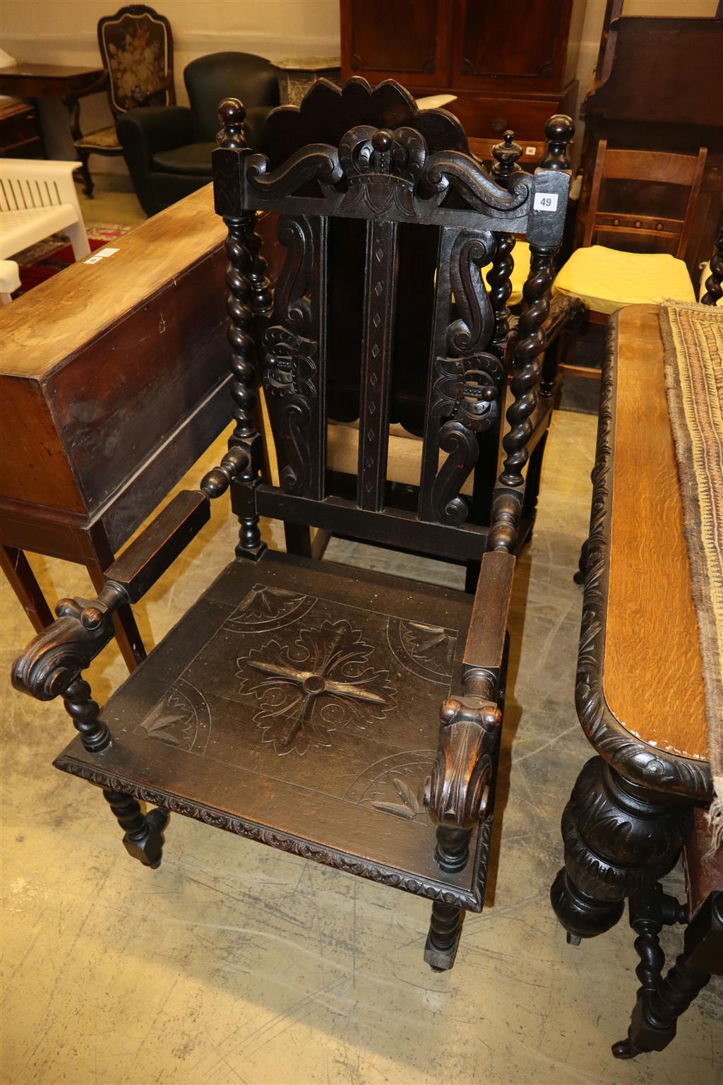 A near pair of Flemish carved oak elbow chairs, larger width 65cm x depth 60cm, height 126cm