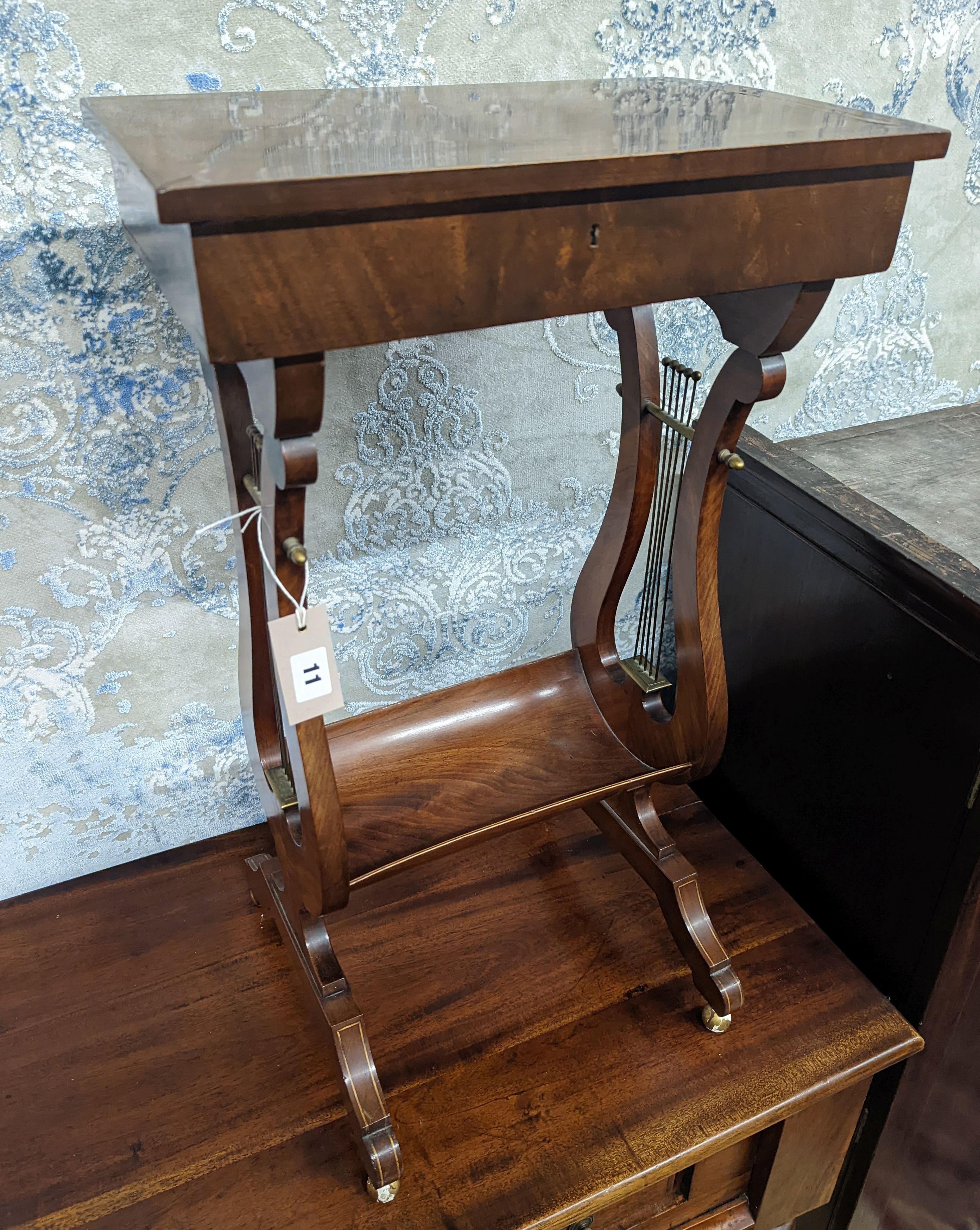 A reproduction Regency style mahogany work table on lyre supports, width 39cm, depth 27cm, height 69cm
