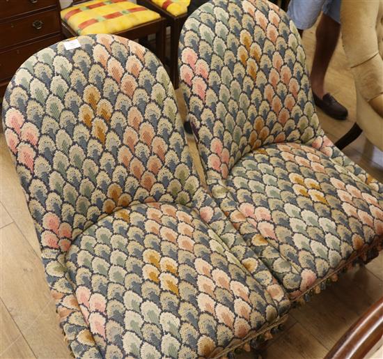 A pair of Victorian rosewood tapestry upholstered nursing chairs A pair of Victorian rosewood tapestry upholstered nursing chairs