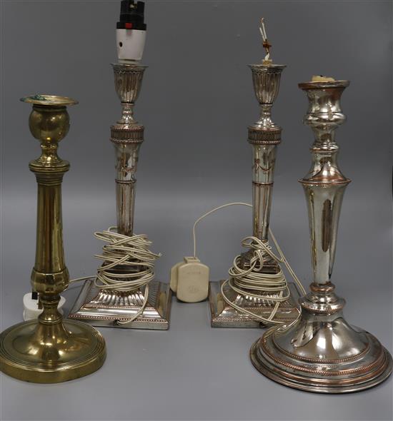 Four plated candlesticks, one fitted as a table lamp Four plated candlesticks, one fitted as a table lamp