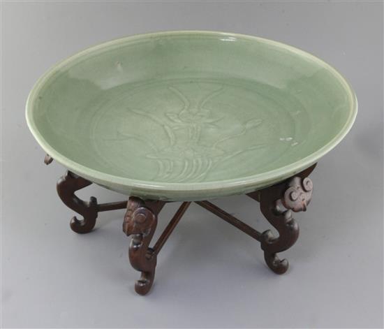 A Chinese Ming dynasty Longquan celadon dish, 15th century, d. 45cm, hongmu stand, A Chinese Ming dynasty Longquan celadon dish, 15th century, d. 45cm, hongmu stand,