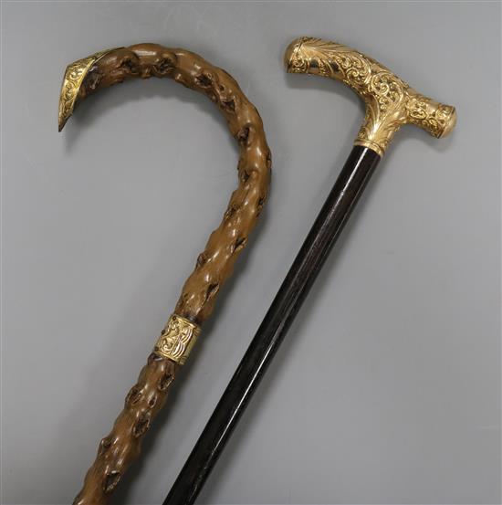 An 18ct gold mounted cane and a gold plated cane longest 91cm