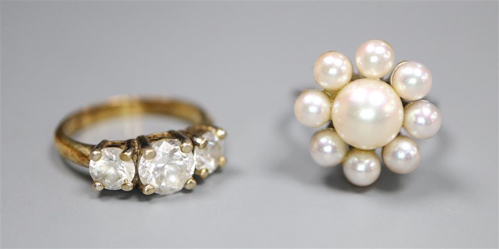 A modern 18ct white gold and cultured pearl cluster ring and a paste three stone ring