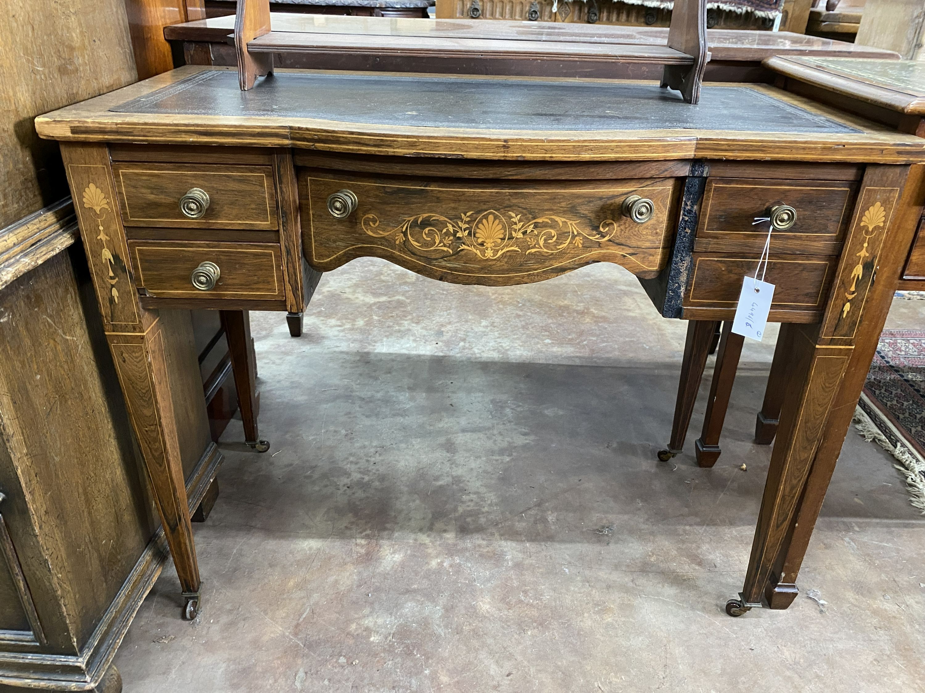 An Edwardian rosewood and marquetry inlaid bow front writing table, width 91cm, depth 49cm, height 72cm and a Victorian walnut three tier wall bracket