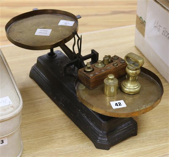 A set of Victorian black painted cast iron scales, with brass pans and weights A set of Victorian black painted cast iron scales, with brass pans and weights