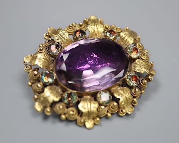 A Victorian yellow metal, foil backed amethyst and white paste set oval brooch, 34mm, gross 9.2 grams.