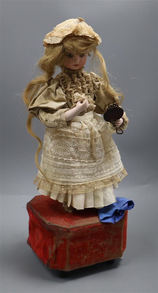 A Roullet et Decamps lady with powder puff and mirror automaton with a closed mouth Jumeau head, H.45cm, some wear to fabrics A Roullet et Decamps lady with powder puff and mirror automaton with a closed mouth Jumeau head, H.45cm, some wear to fabrics