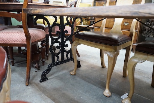 A Victorian style cast metal garden table with waney edged oak plank top, length 122cm, depth 76cm, height 68cm