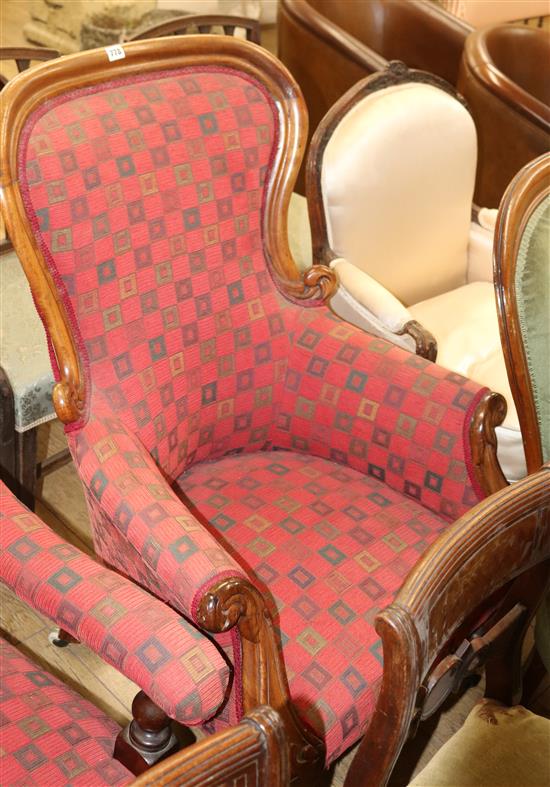 An upholstered spoonback armchair An upholstered spoonback armchair