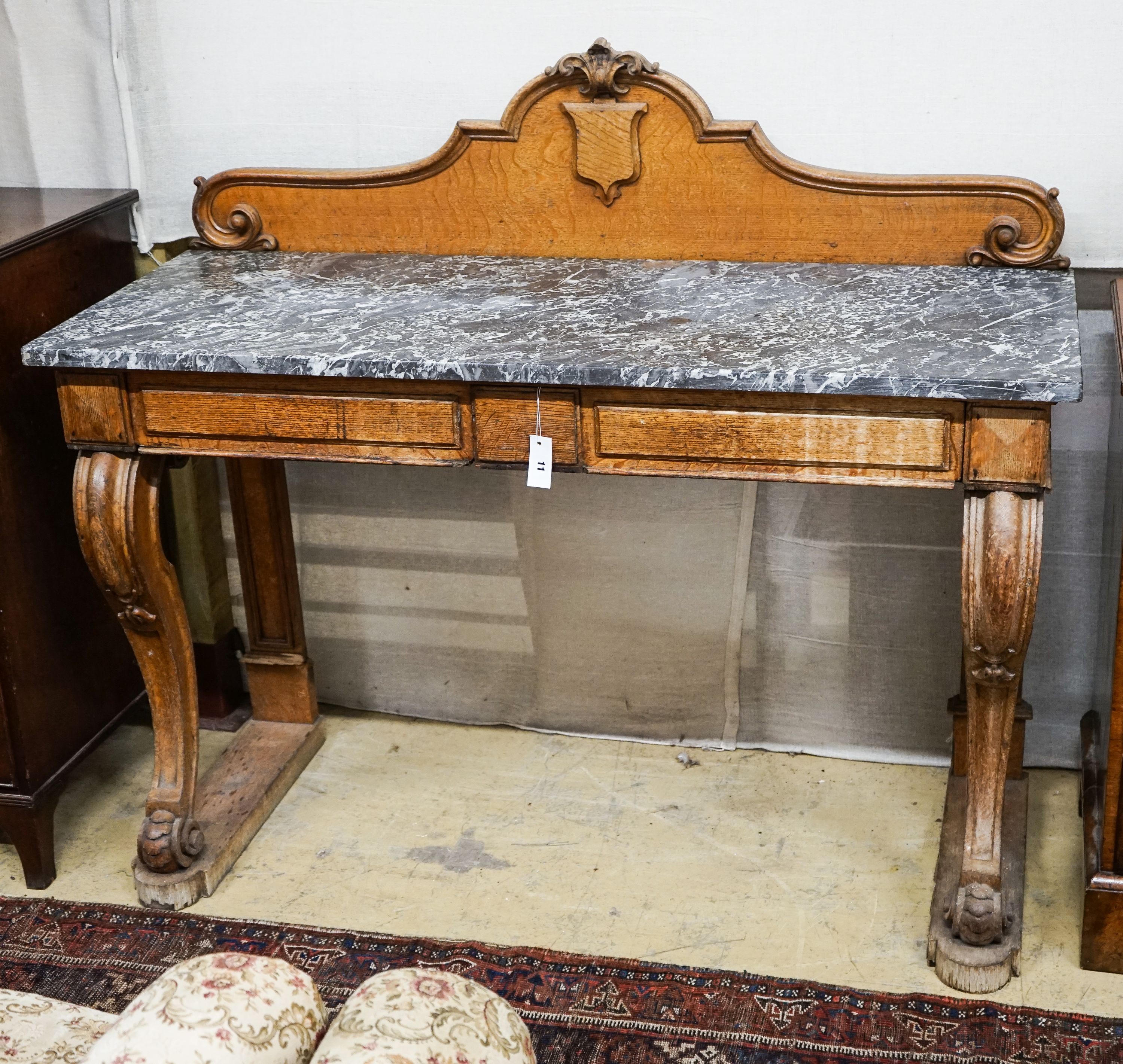 A mid Victorian oak marble topped two drawer console table, width 138cm, depth 54cm, height 120cm