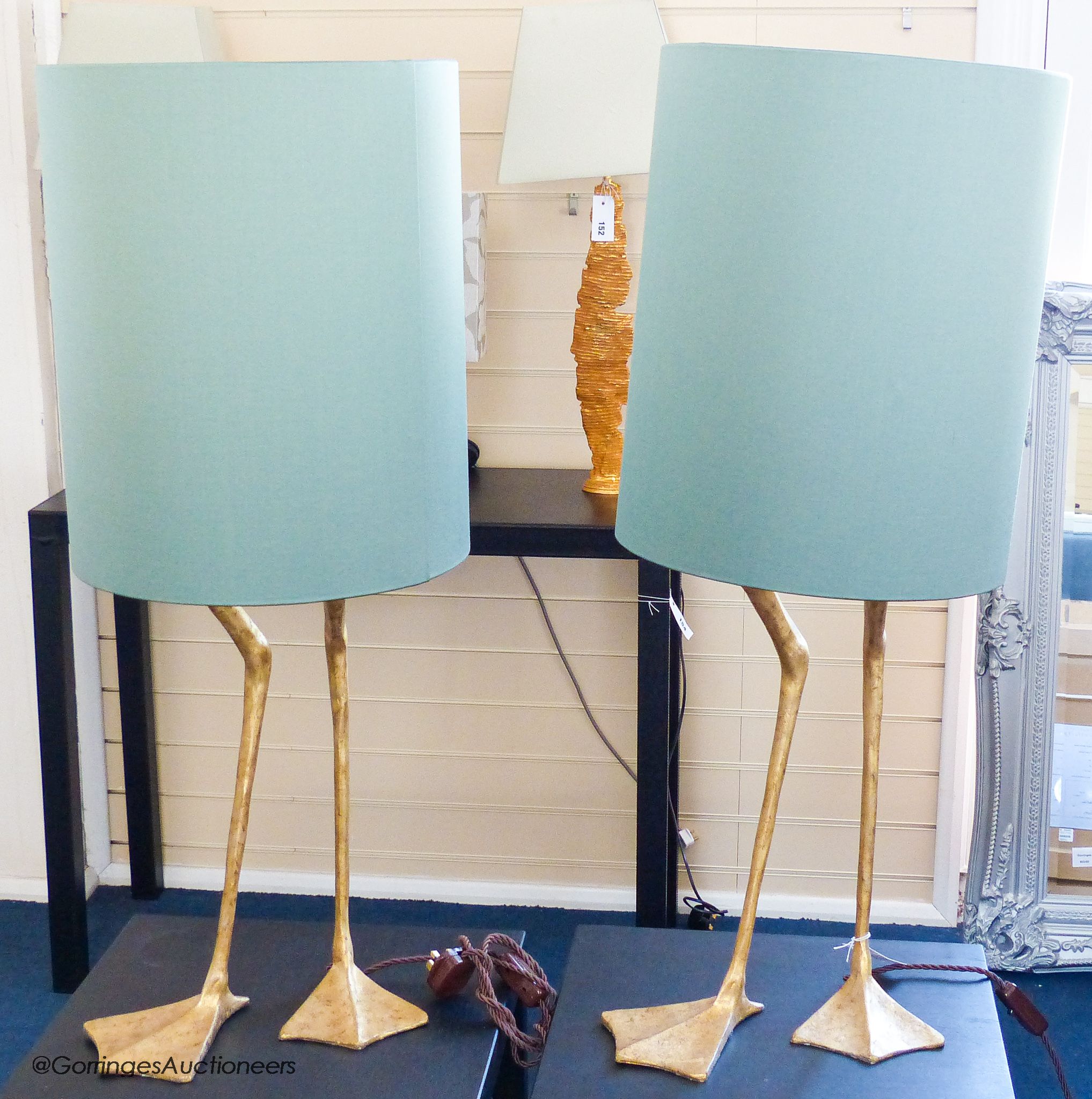 A pair of gilt composition 'goose leg' table lamps, duck egg shades, total height 93 cm
