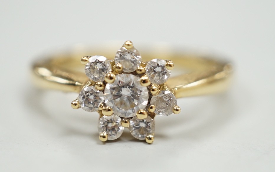 A modern yellow metal and diamond set flower head cluster ring, size L, gross weight 2.9 grams.                                                                                                                             