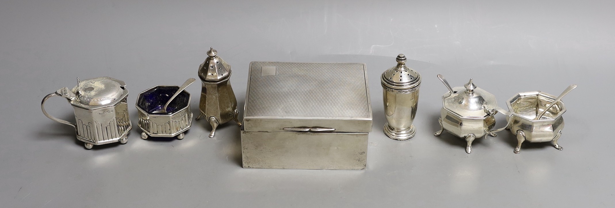 Six assorted silver condiments and a silver mounted cigarette box.                                                                                                                                                          