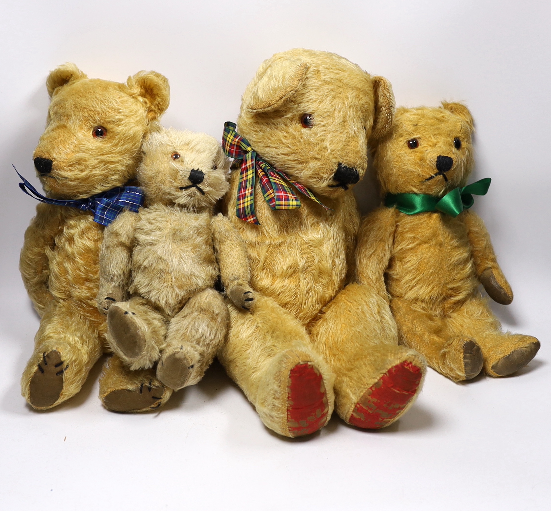 Three Chilterns bears, 1950's, worn, and a large English bear, 42cm (4)                                                                                                                                                     