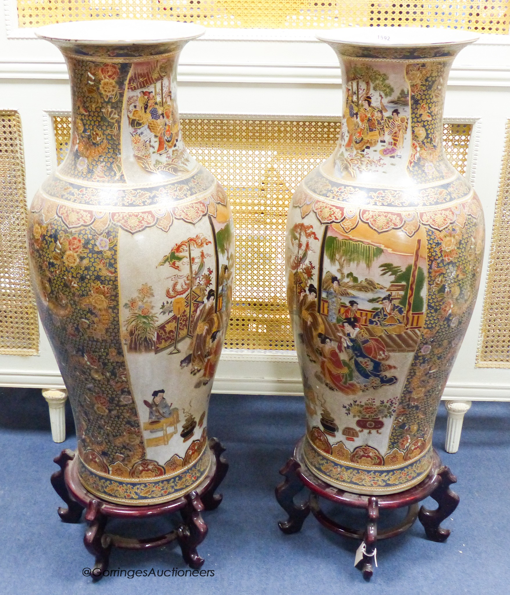 A pair of large Japanese vases, on hardwood stands                                                                                                                                                                          