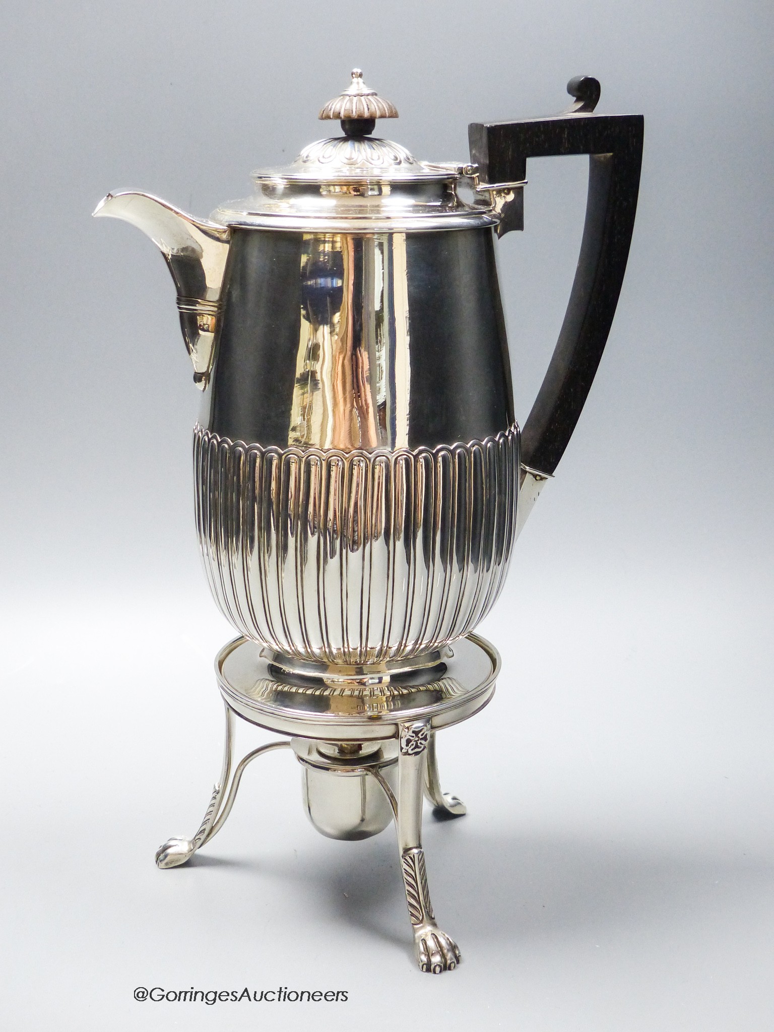 A George III demi fluted silver biggin pot, Burwash & Sibley, London, 1810, on a later matches stand with burner, stand marked for William Bennett, London, 1814, overall 32cm, gross 34.5oz.                               