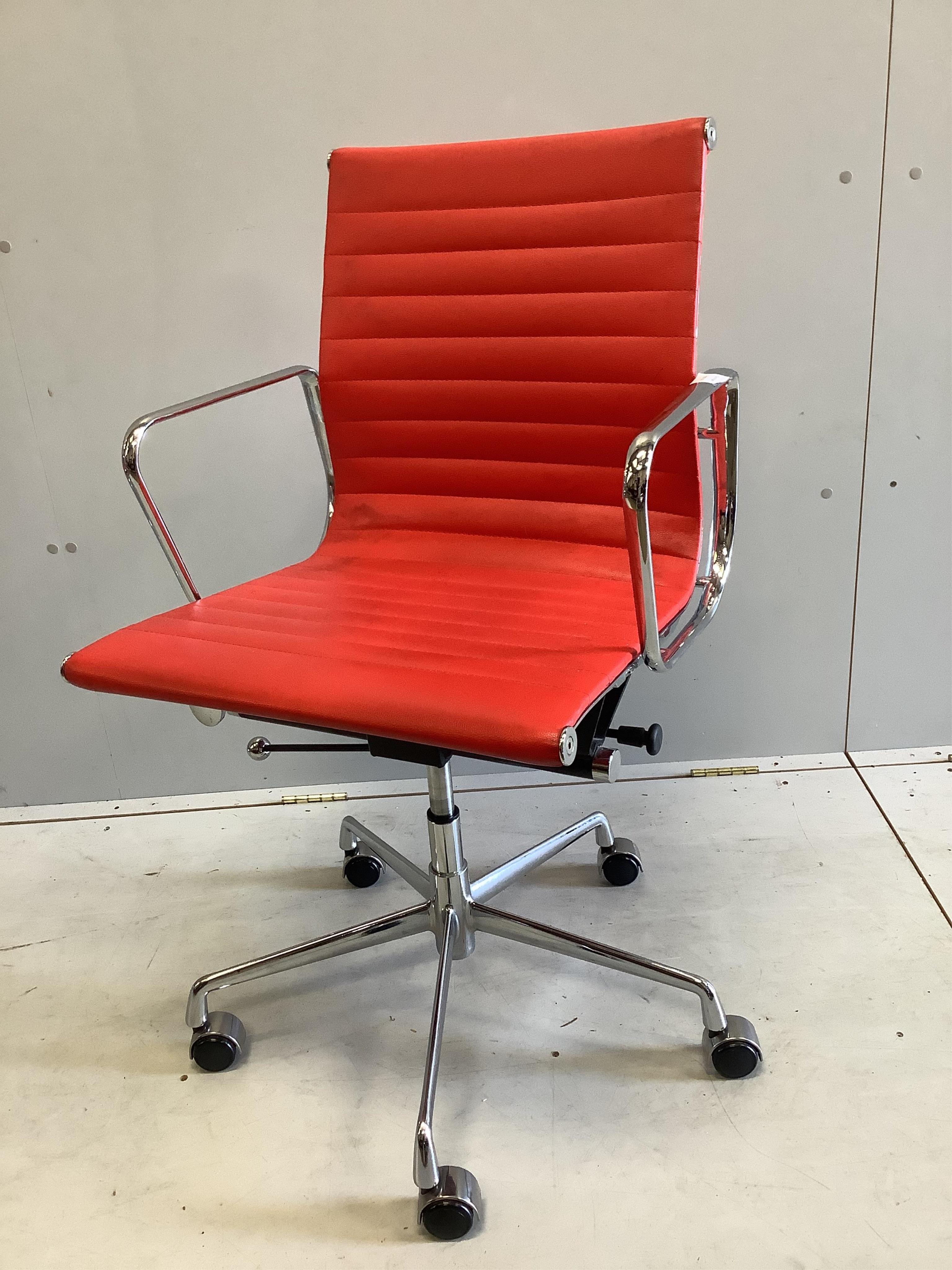 A Vitra Eames red desk chair, width 56cm, depth 50cm, height 98cm. Condition - good                                                                                                                                         