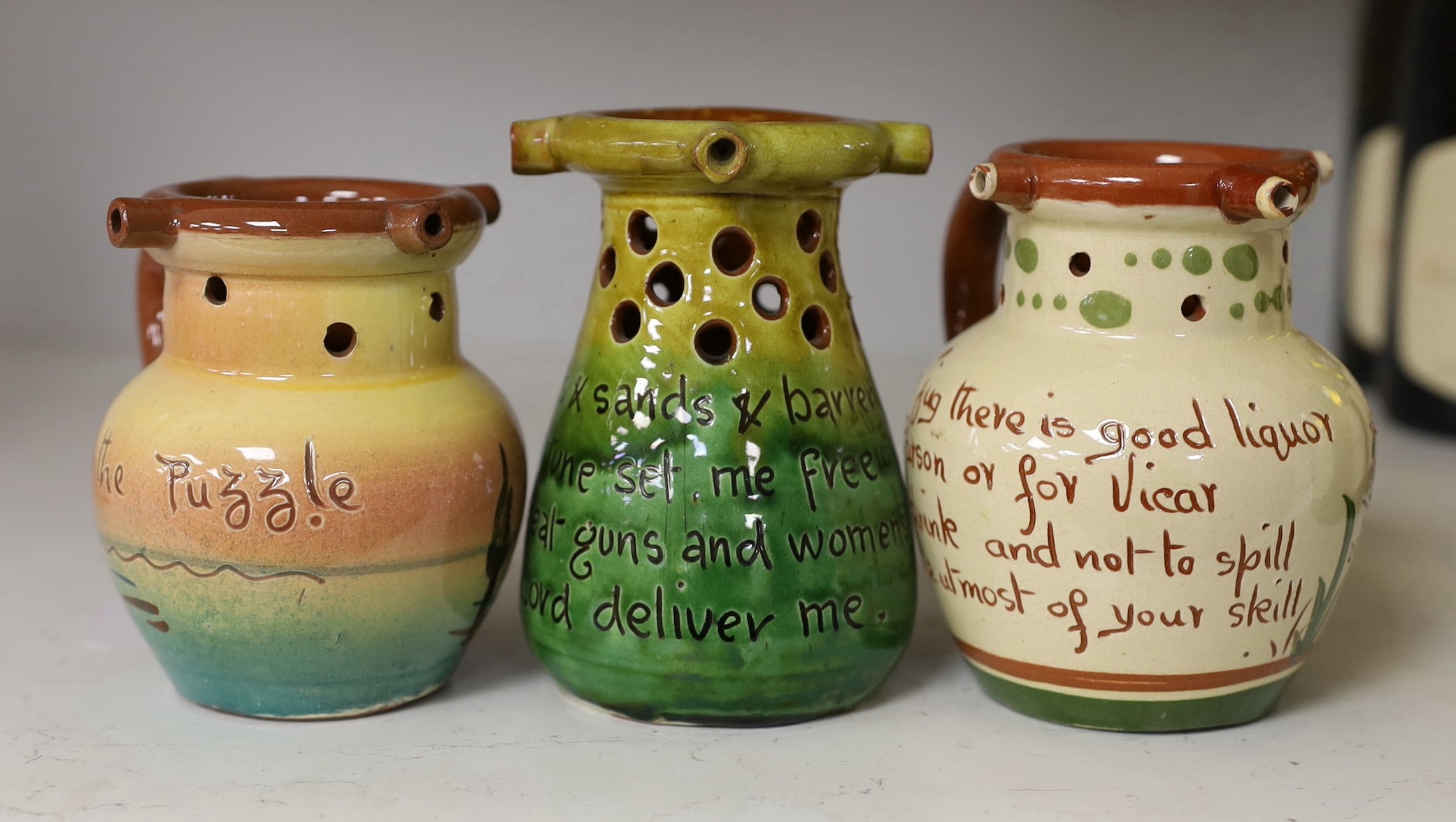 Three West Country mottoware puzzle jugs. Tallest 12cm                                                                                                                                                                      