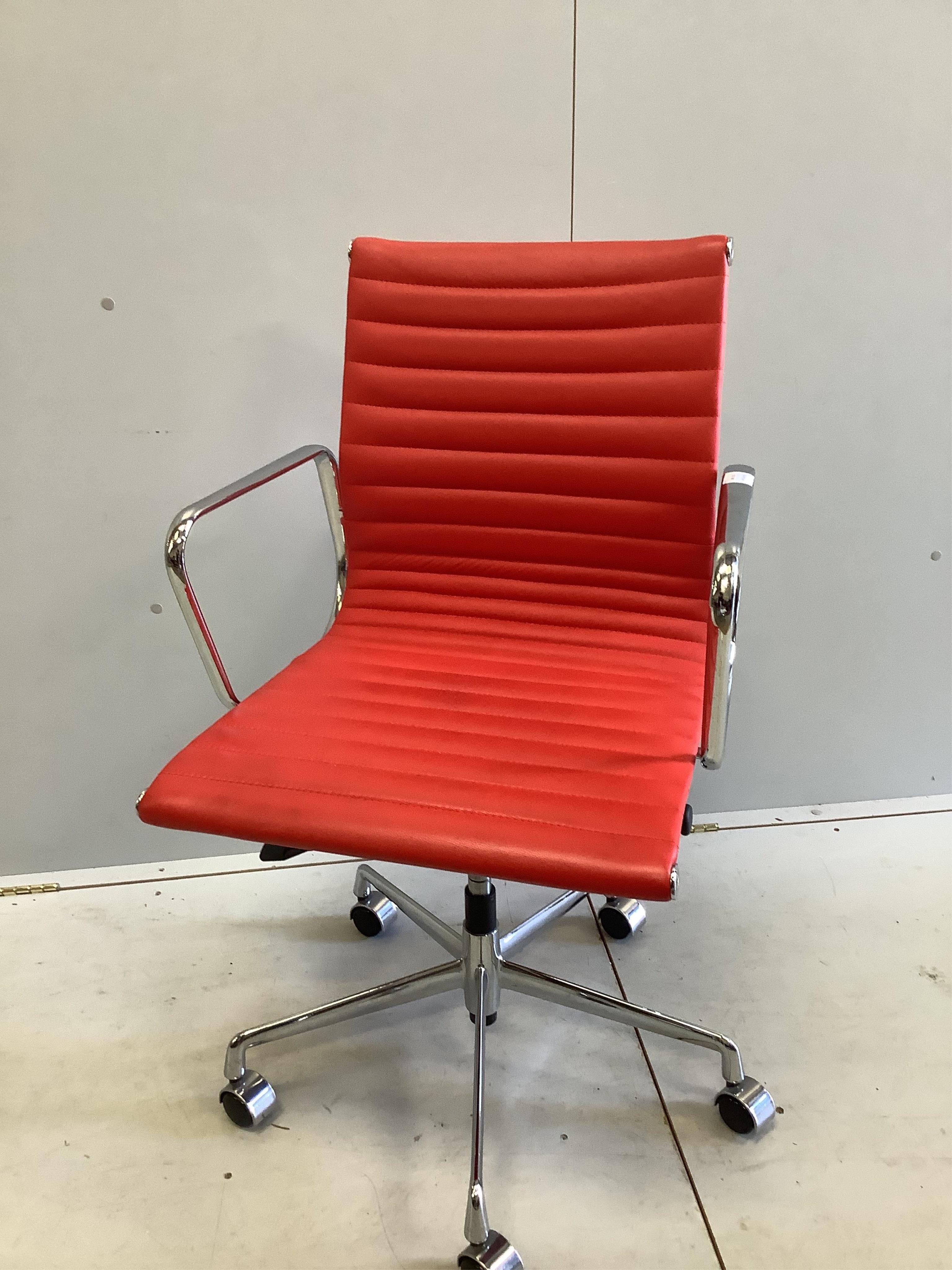 A Vitra Eames red desk chair, width 56cm, depth 50cm, height 98cm. Condition - good                                                                                                                                         