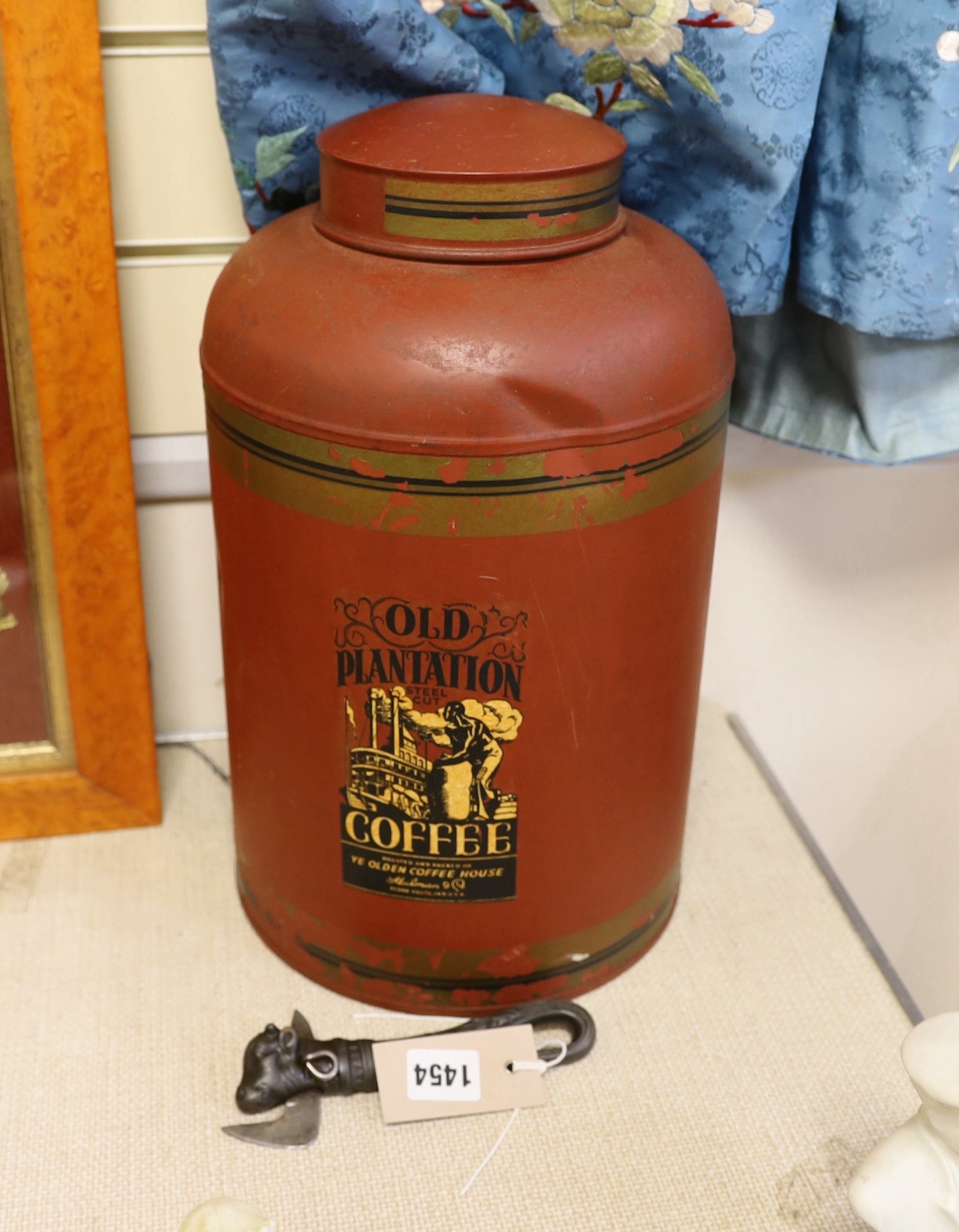 A large toleware tin coffee canister and a novelty iron can opener, canister 38cms high                                                                                                                                     