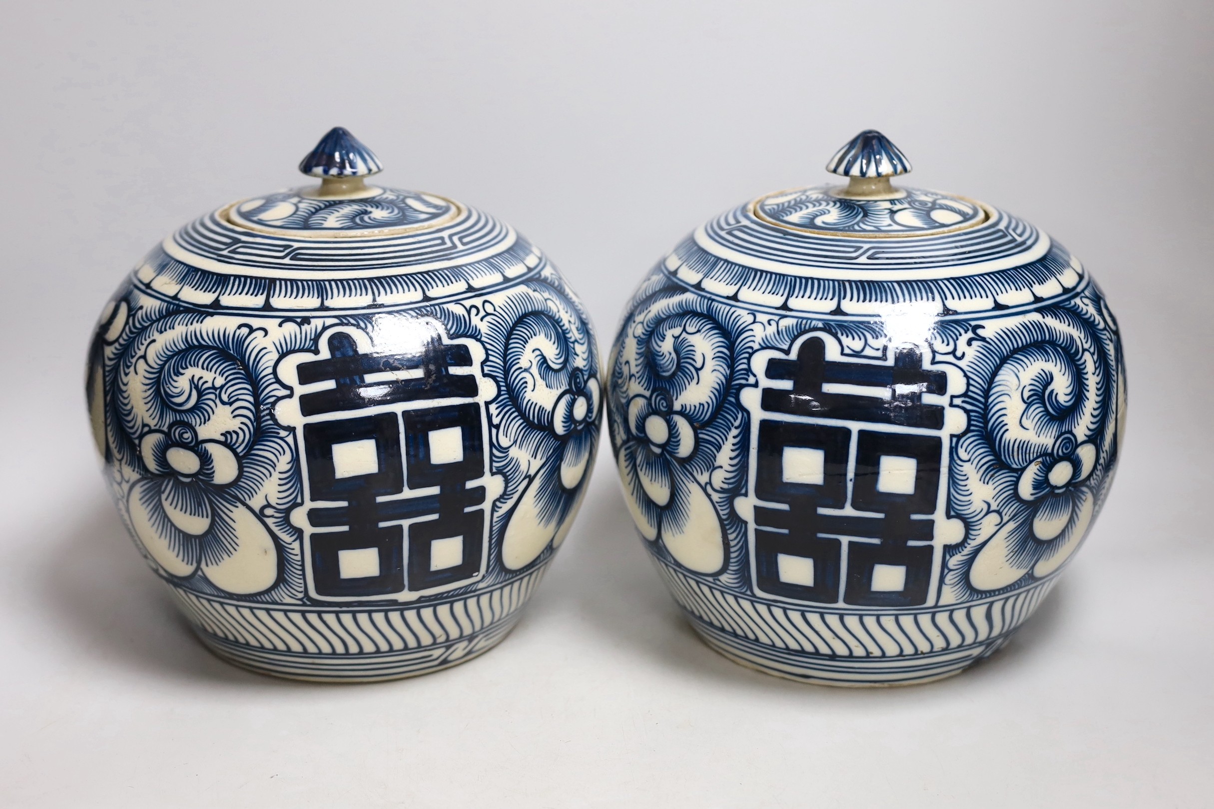 A pair of Chinese blue and white ‘Shuangxi’ jars and cover, 25cms high                                                                                                                                                      