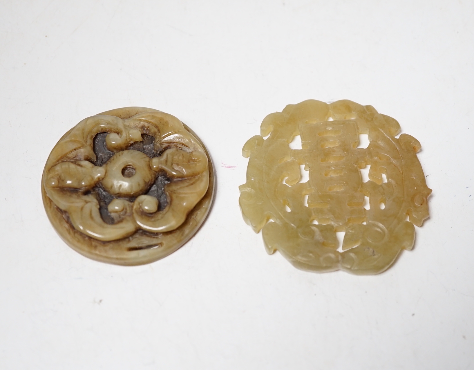 Two Chinese carved bowenite jade discs, largest 6cm diameter                                                                                                                                                                