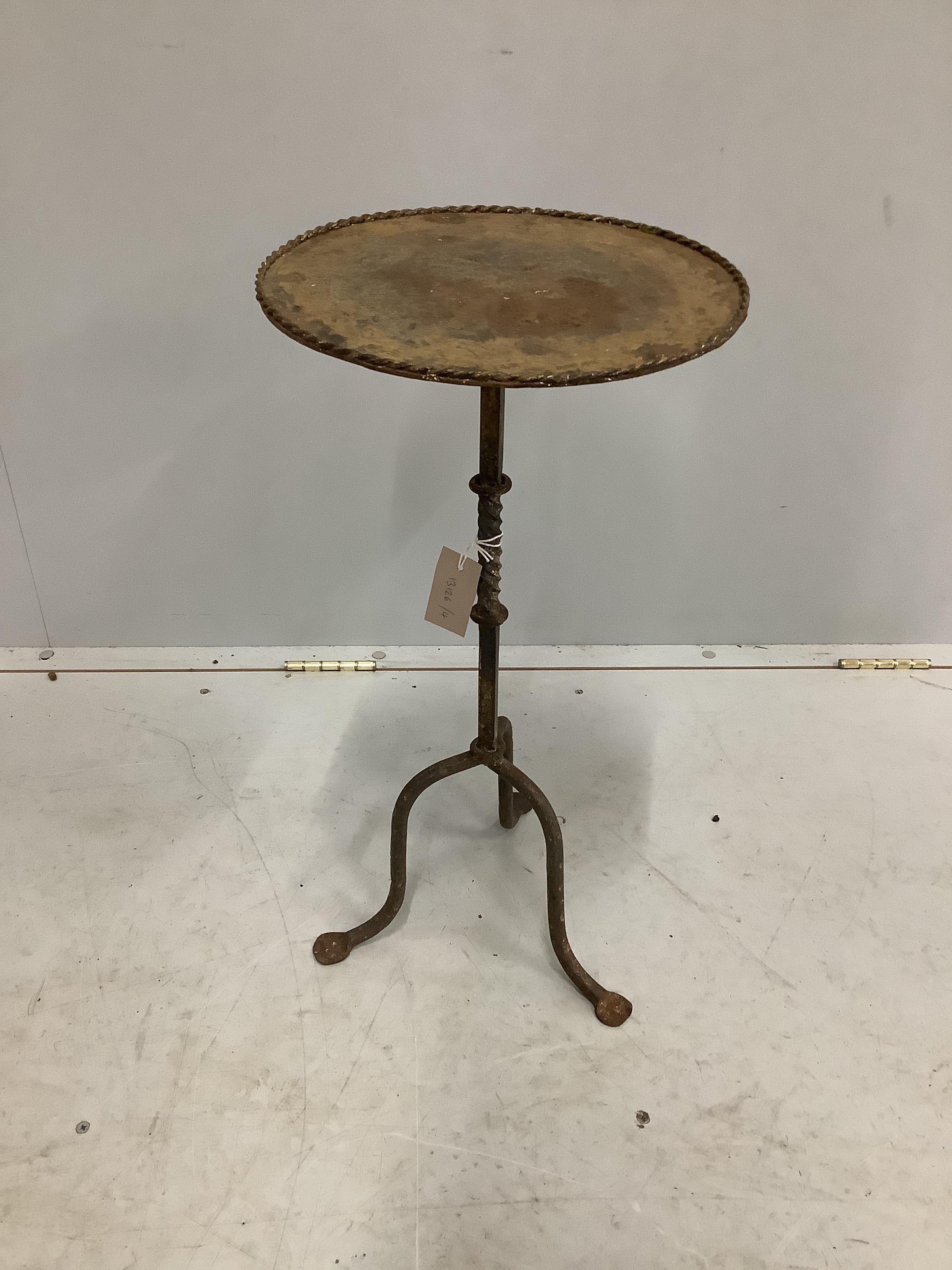 A circular wrought iron tripod wine table, diameter 31cm, height 60cm                                                                                                                                                       