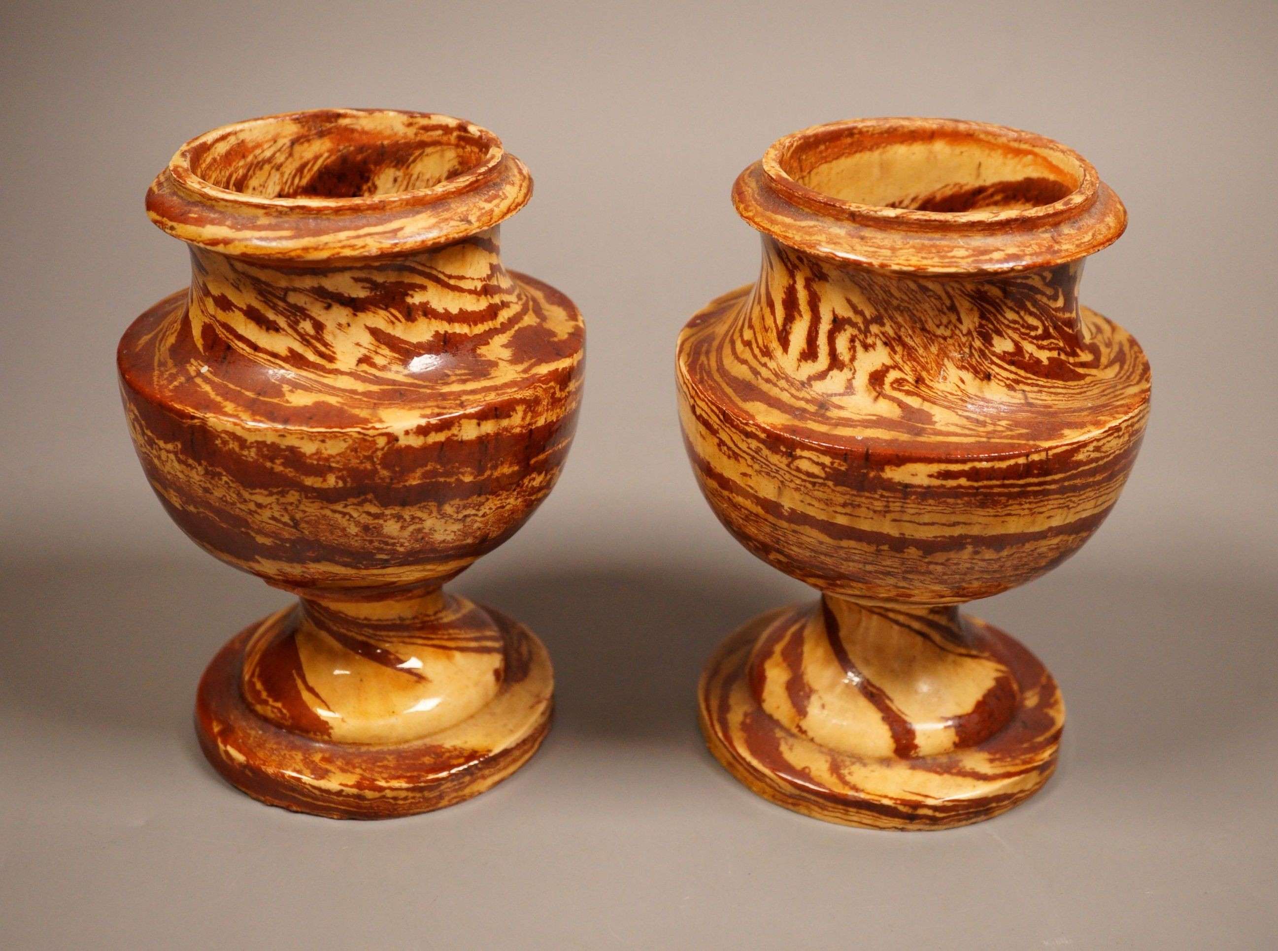 A pair of 19th century 'solid agate' pottery urns 14cm                                                                                                                                                                      