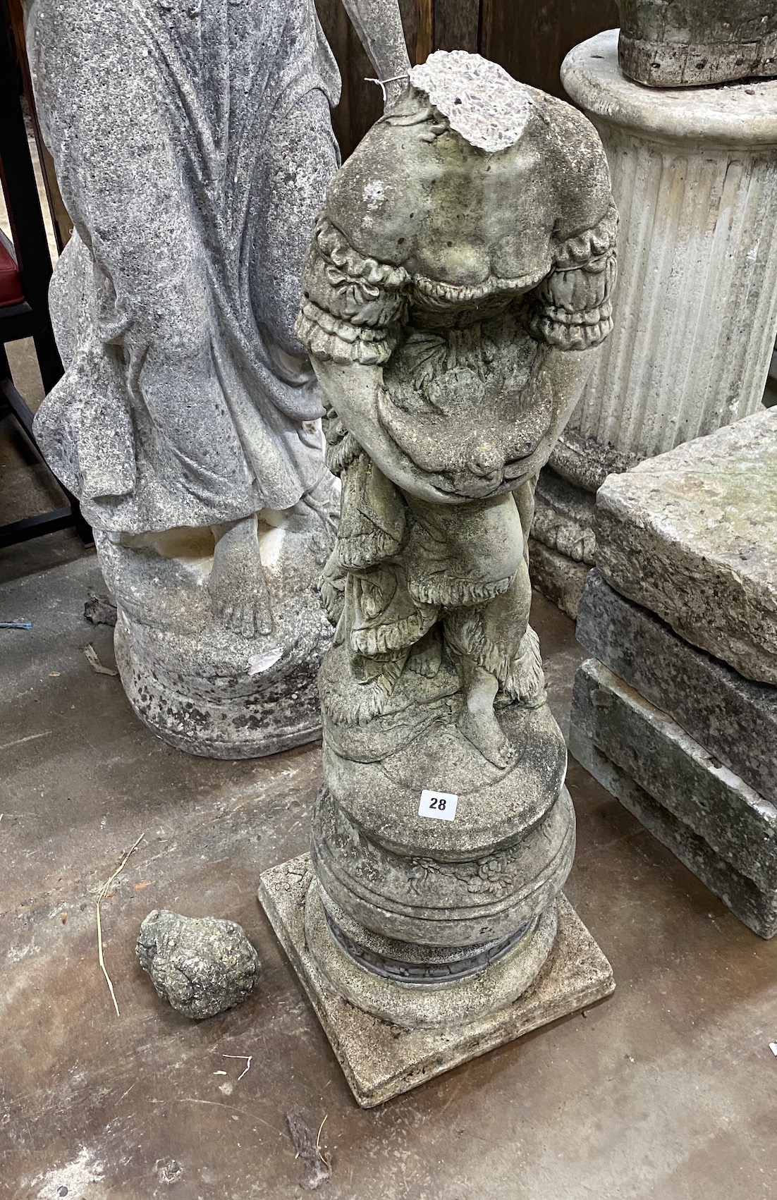 A reconstituted stone garden statue of a lady holding a dove, head detached, height 95cm                                                                                                                                    