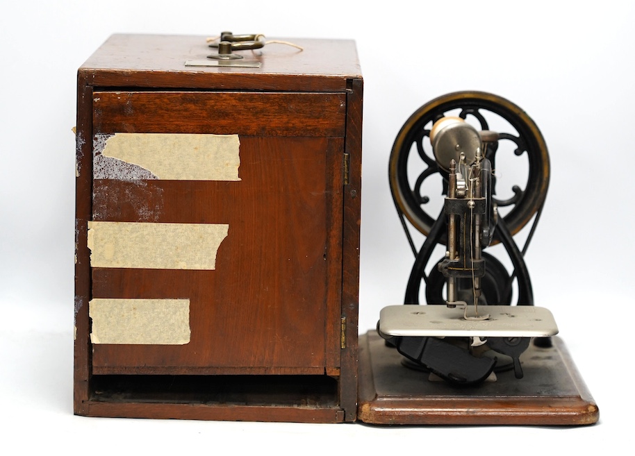 A late 19th/early 20th century Willcox & Gibbs swan neck sewing machine, with its original mahogany case, engraved brass owners label to top of case. Condition - fair to good                                              