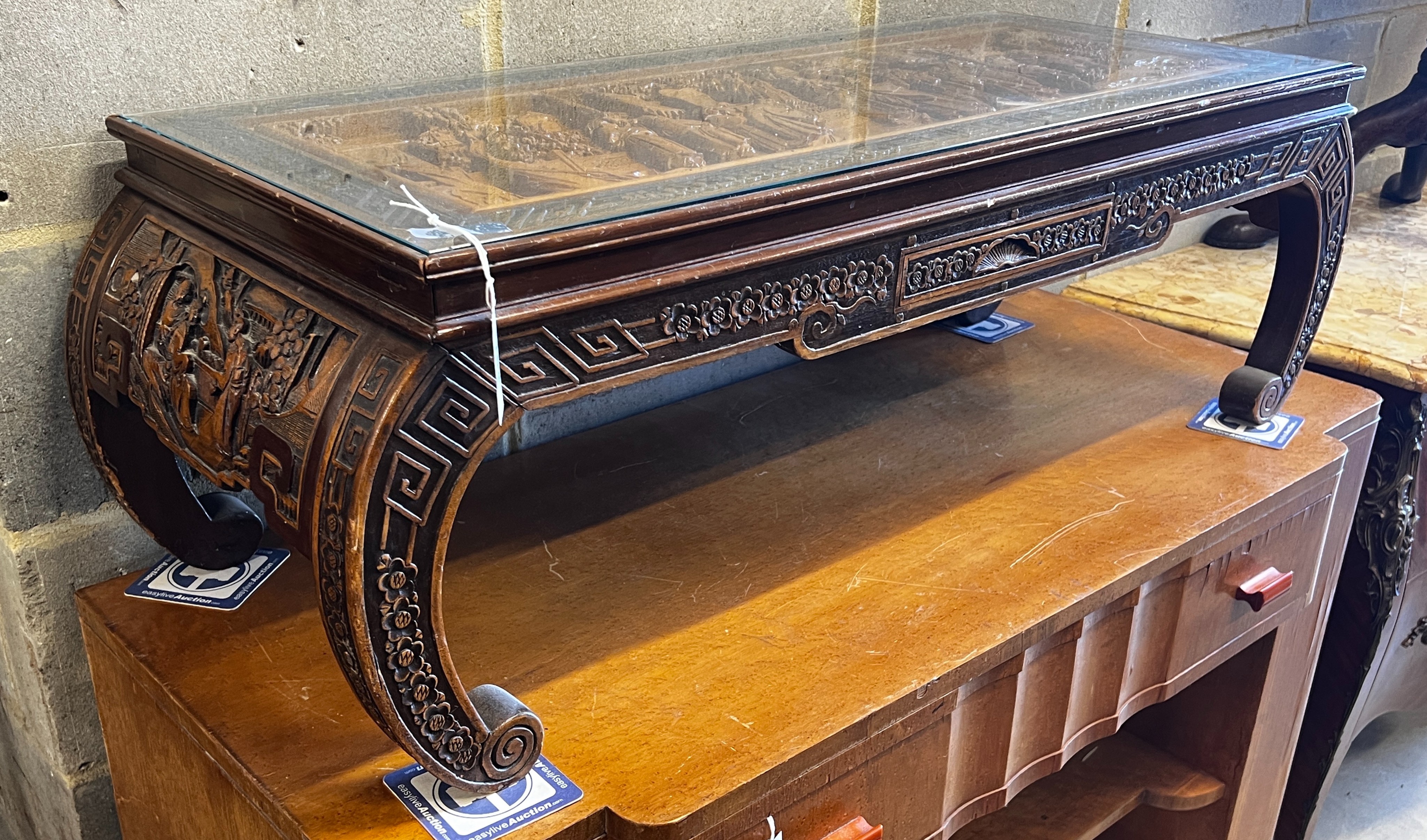 A Chinese carved hardwood low table, length 110cm, depth 43cm, height 36cm                                                                                                                                                  