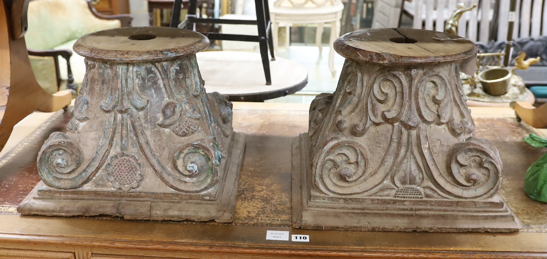 A near pair of carved and painted wood Corinthian column capitals, width 41cm, depth 41cm, height 31cm                                                                                                                      