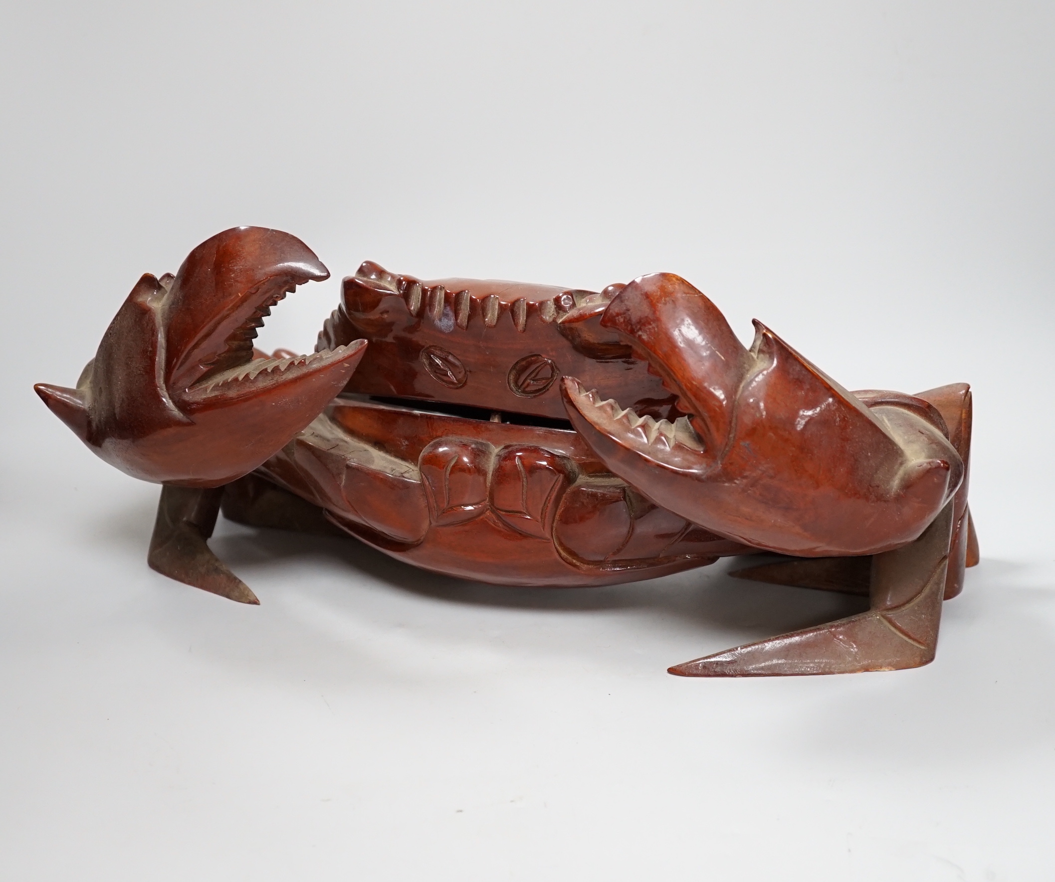 A large carved hardwood crab with hinged lid opening to reveal a compartment, 44cm wide                                                                                                                                     