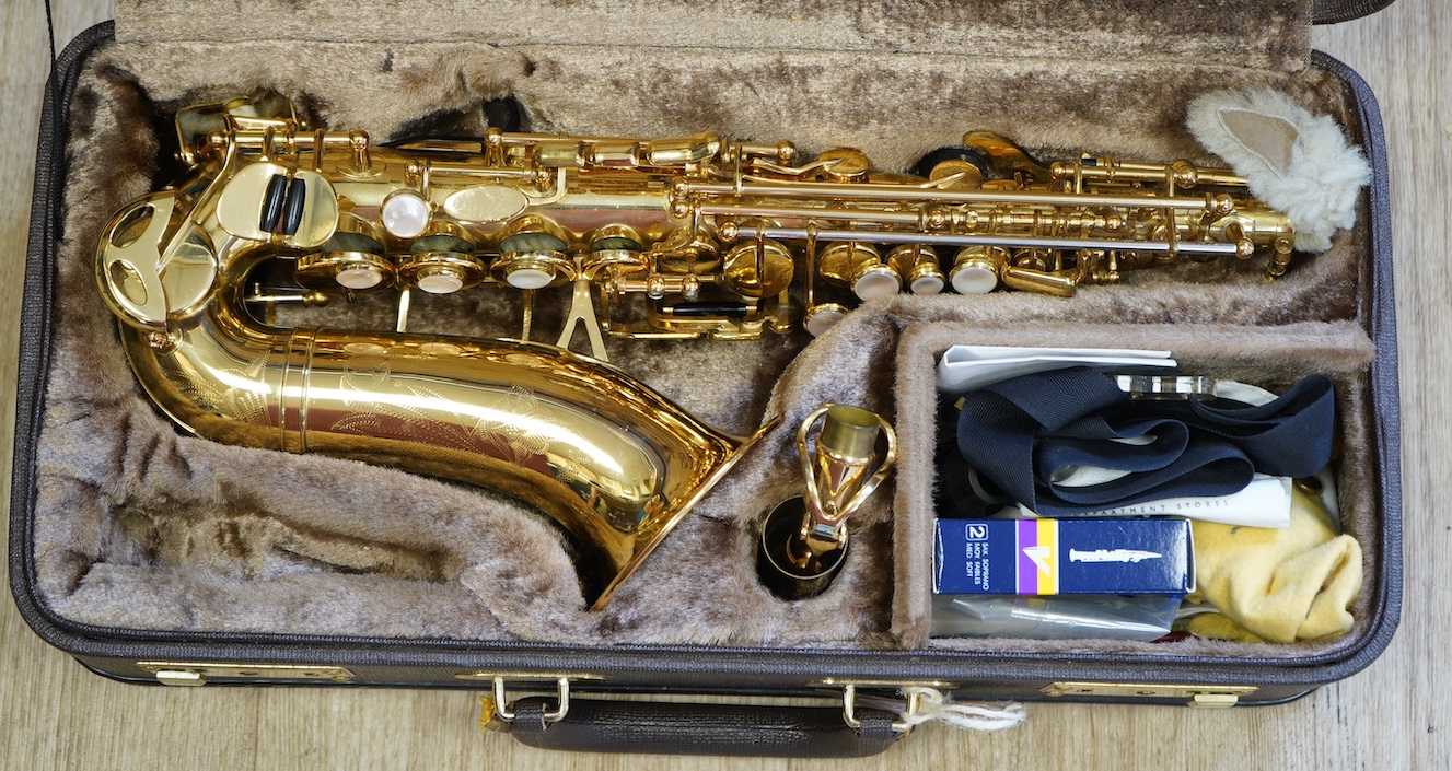 A cased Yanagisawa brass soprano saxophone with engraved decoration. Condition - good                                                                                                                                       