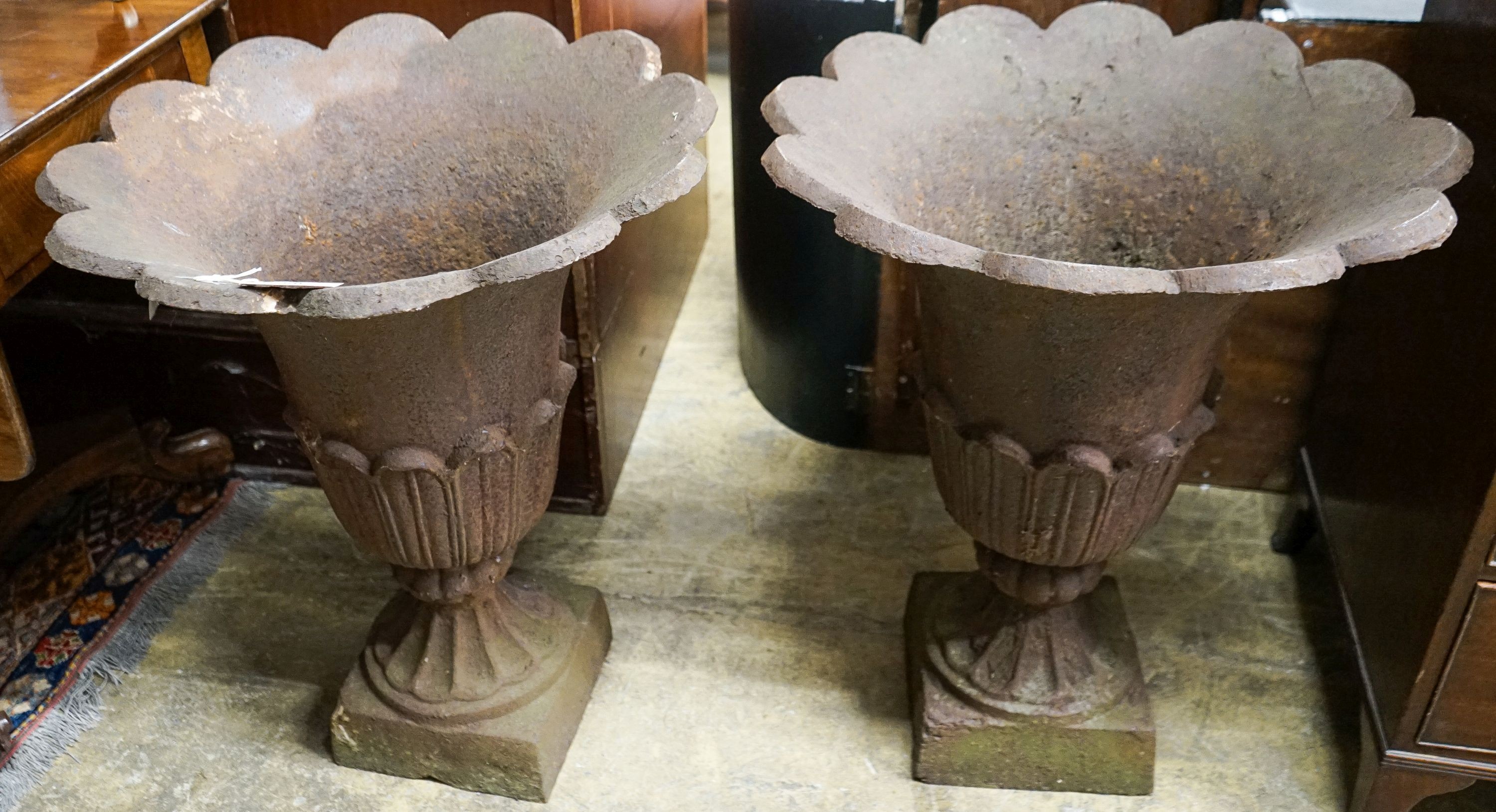 A pair of cast iron tulip urns, mid 19th century, diameter 60cm, height 75cm                                                                                                                                                