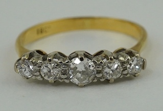 An 18ct and five stone graduated diamond set half hoop ring, size L, gross weight 2.4 grams. Condition - fair                                                                                                               