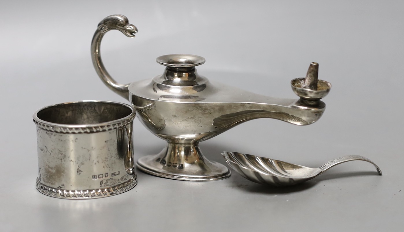 A George V silver 'Aladdin's Lamp' lighter (lacking cover), length 12cm, a silver napkin ring and a William IV silver caddy spoon, William Bateman, London, 1835.                                                           
