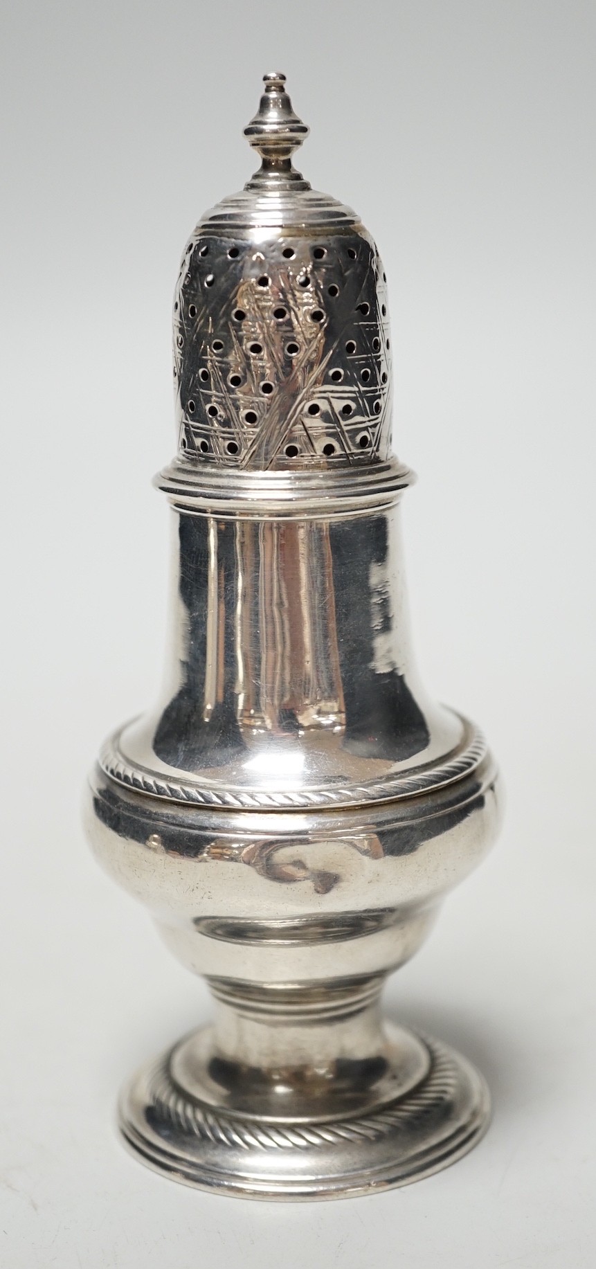 A George II silver baluster pepperette, John Delmester, London, 1757?, 13.1cm, 94 grams.                                                                                                                                    