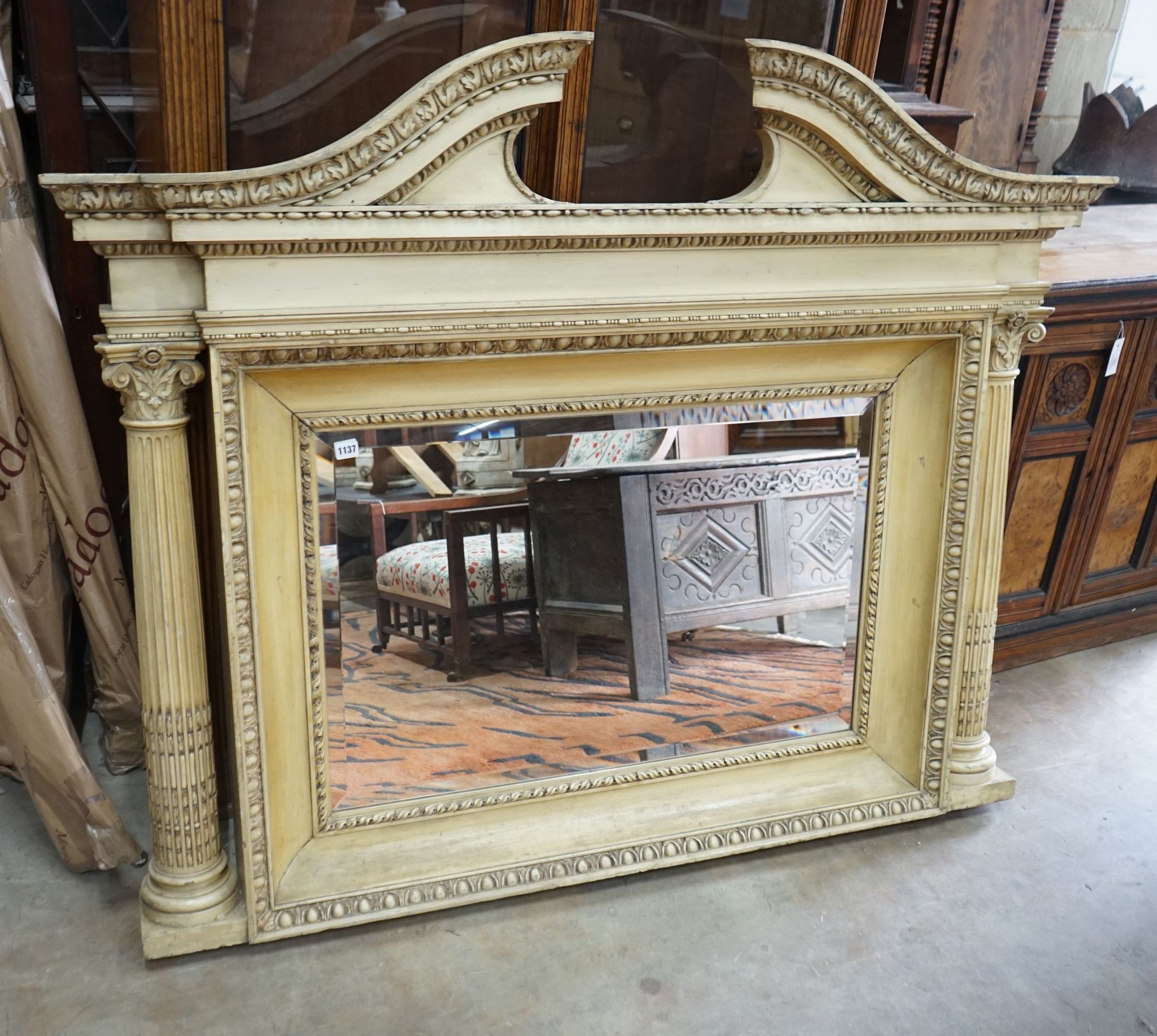 A George III style painted wood and gesso overmantel mirror with rectangular bevelled plate flanked by Corinthian columns, width 152cm, height 122cm                                                                        