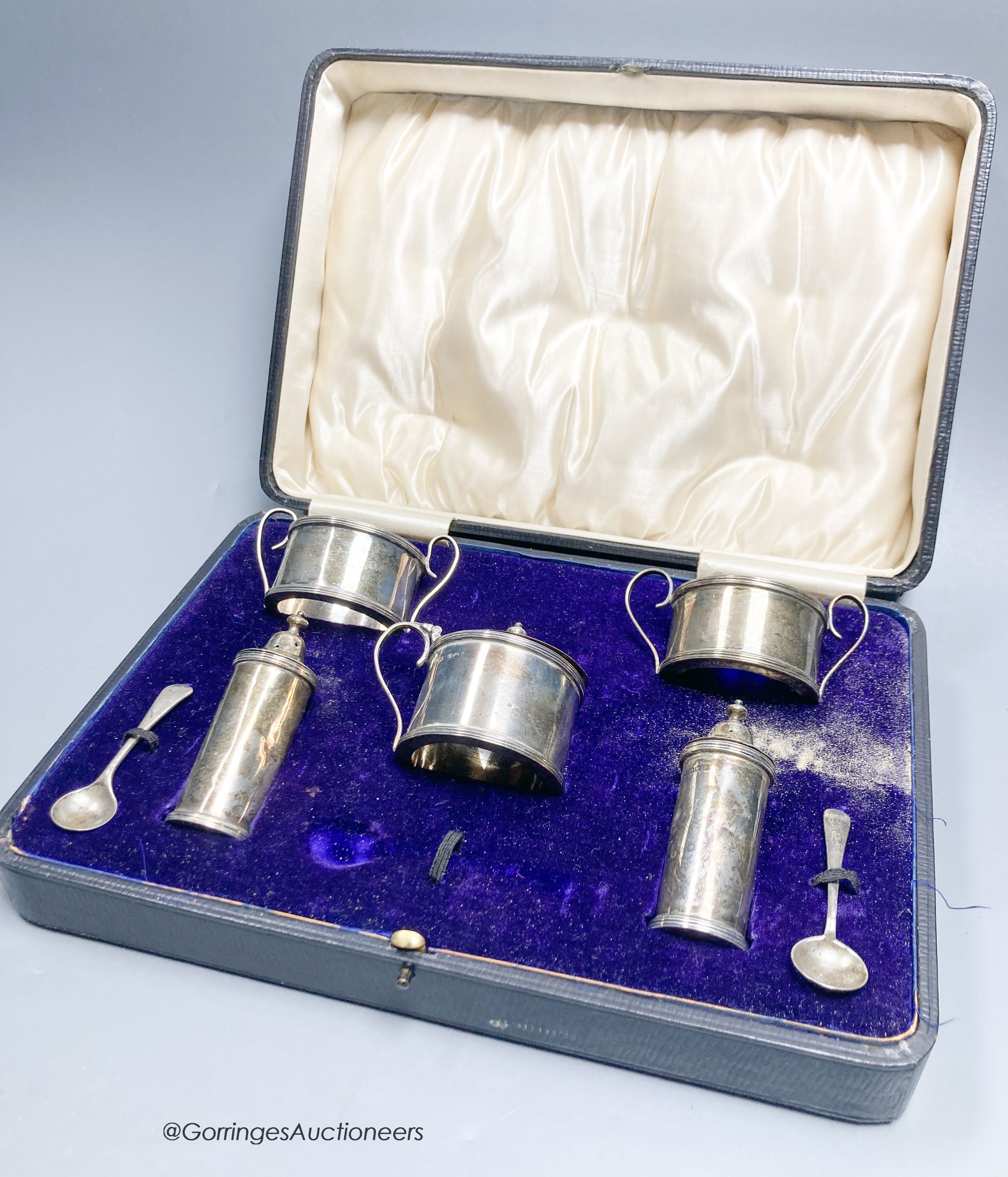 A cased George V silver five piece condiment set and two spoon, Birmingham, 1912.                                                                                                                                           