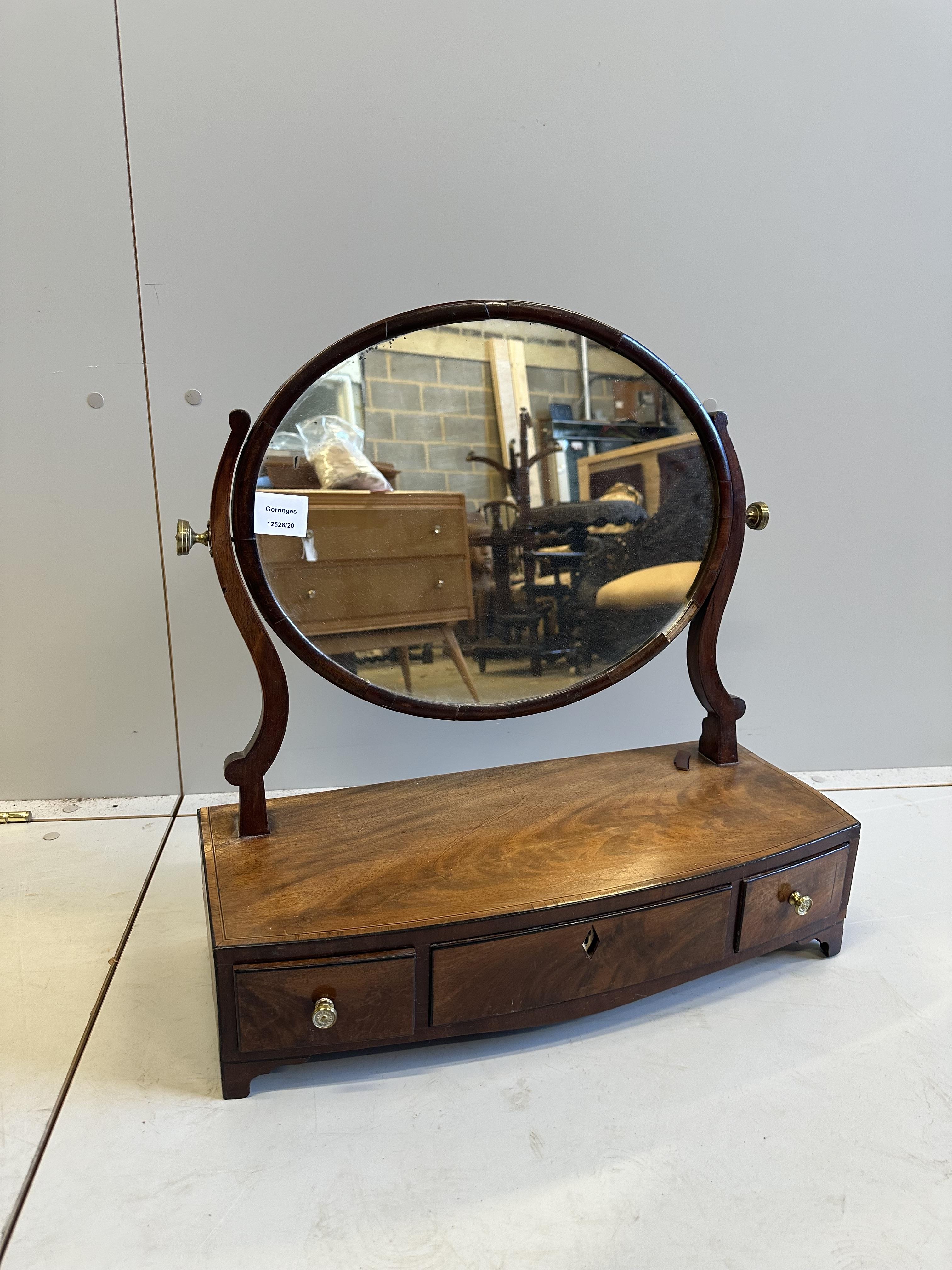 A Regency mahogany bowfront toilet mirror, width 53cm, depth 22cm, height 55cm                                                                                                                                              