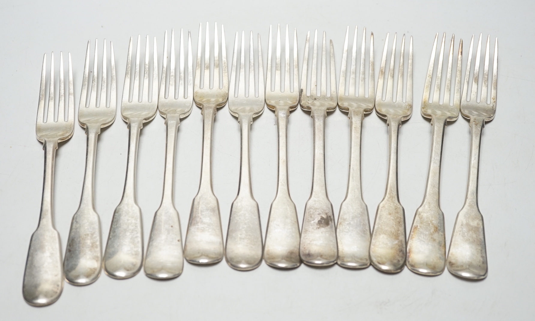 A set of twelve George III silver fiddle pattern table forks, William Eaton? London, 1812,14/15, 29.8oz.                                                                                                                    