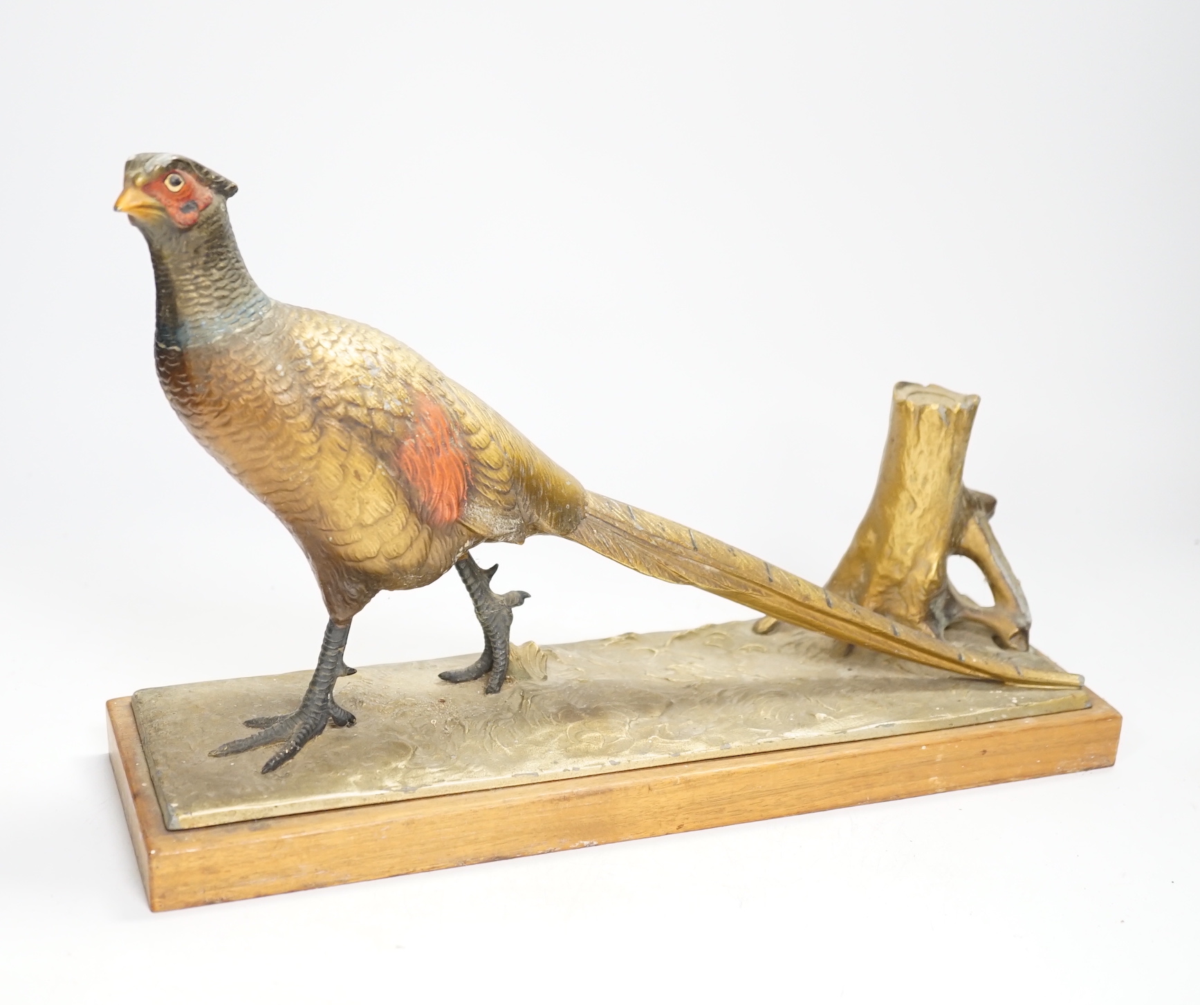 A cold painted spelter table striker, in the form of a pheasant, 31.5cm wide                                                                                                                                                