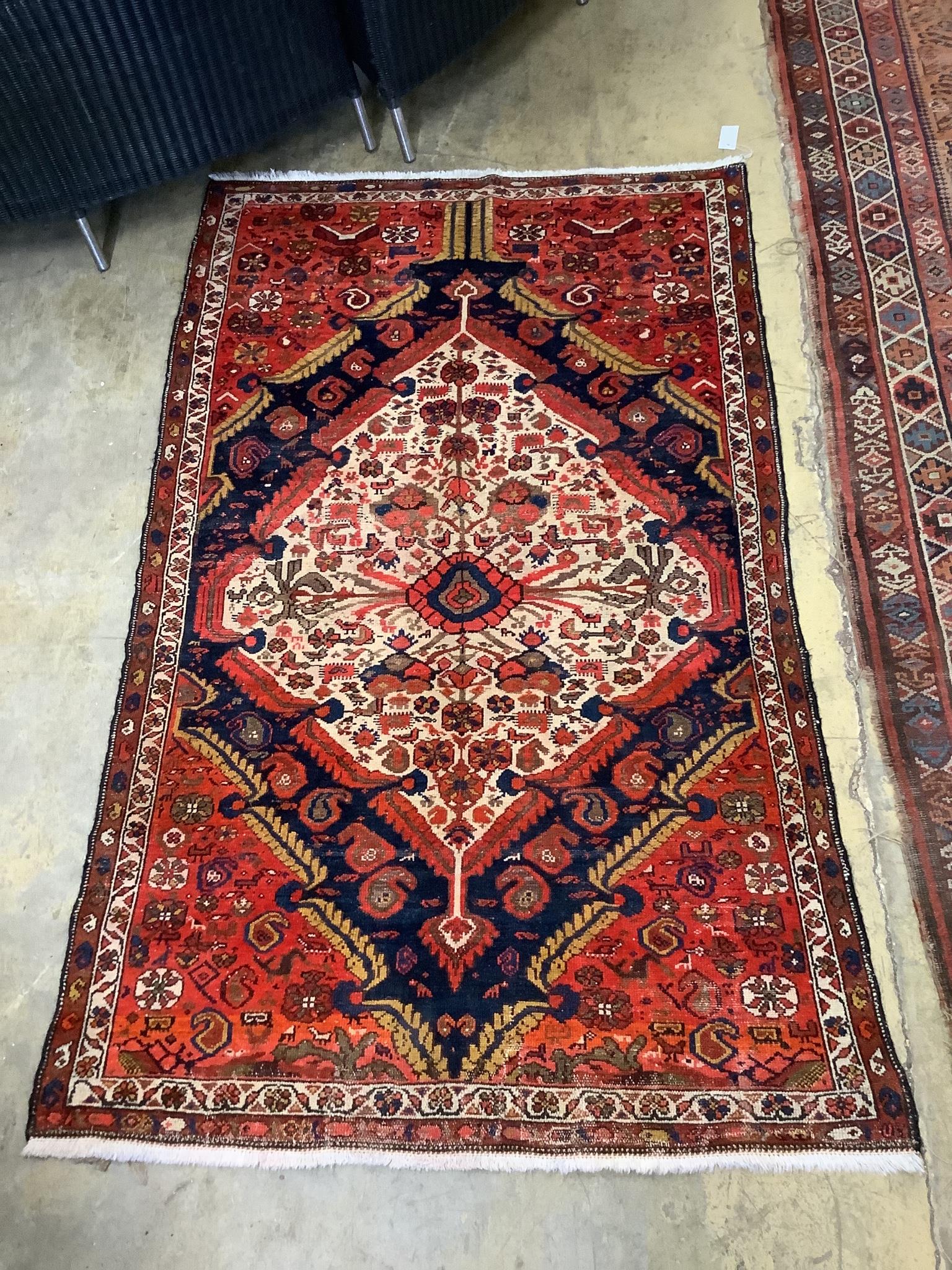 A Persian red ground rug, 196 x 123cm                                                                                                                                                                                       