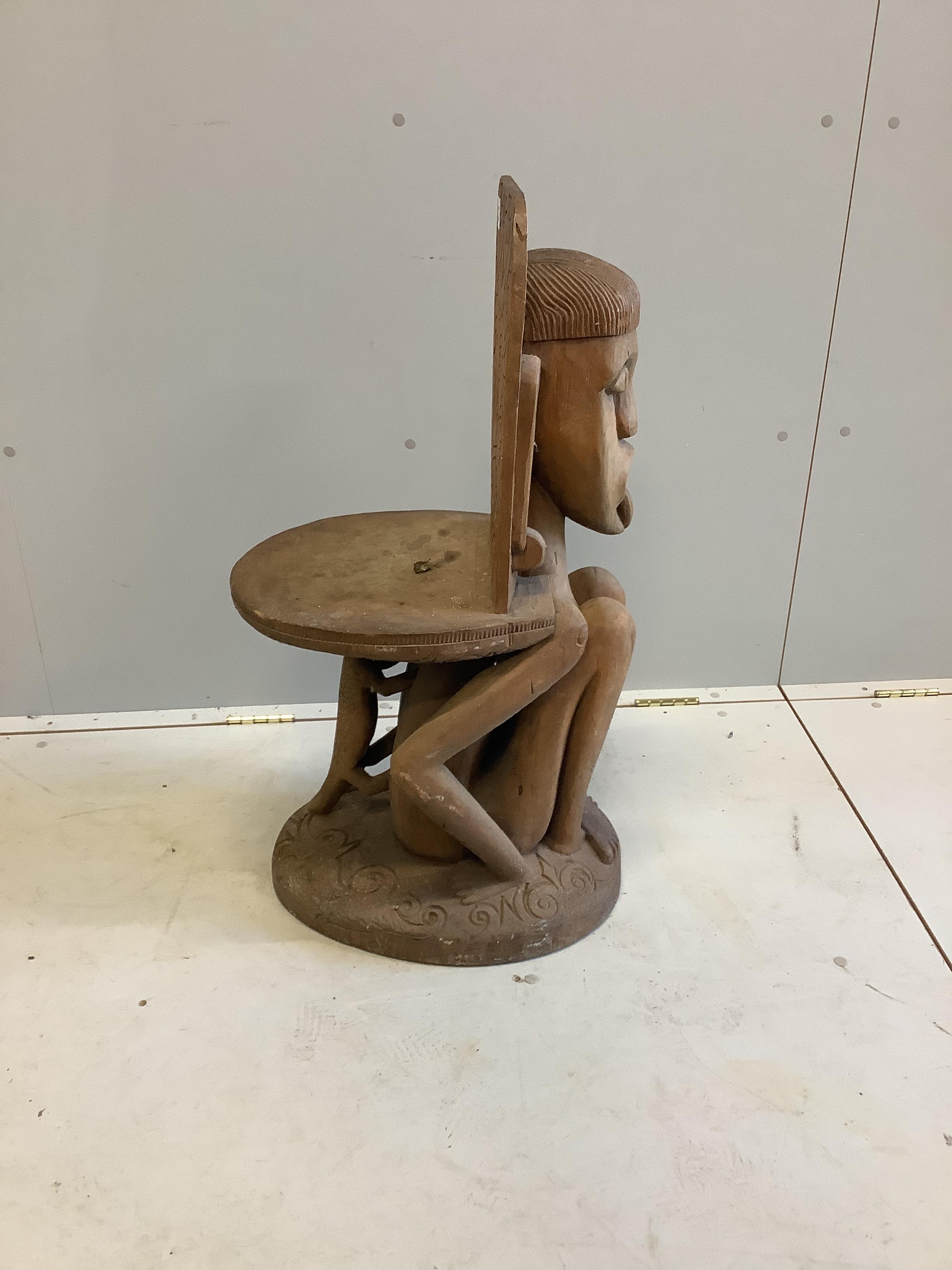 A Sarawak Iban people chair, height 87cm and a book 'Wild People'                                                                                                                                                           