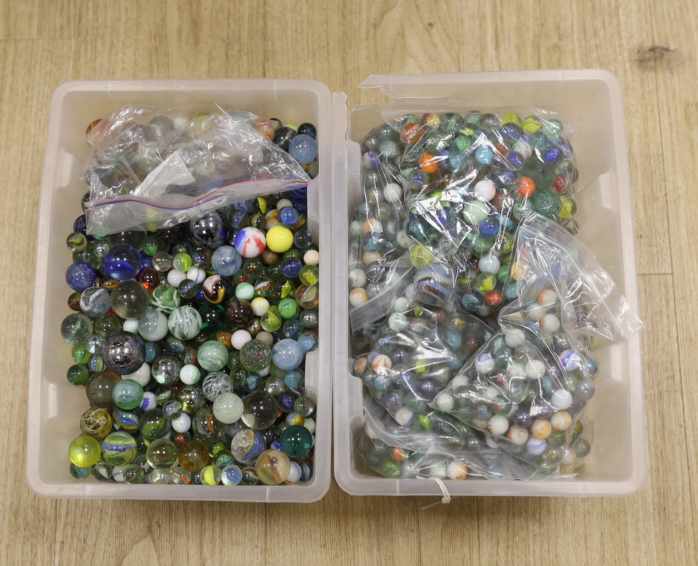 A large collection of glass marbles in two boxes                                                                                                                                                                            