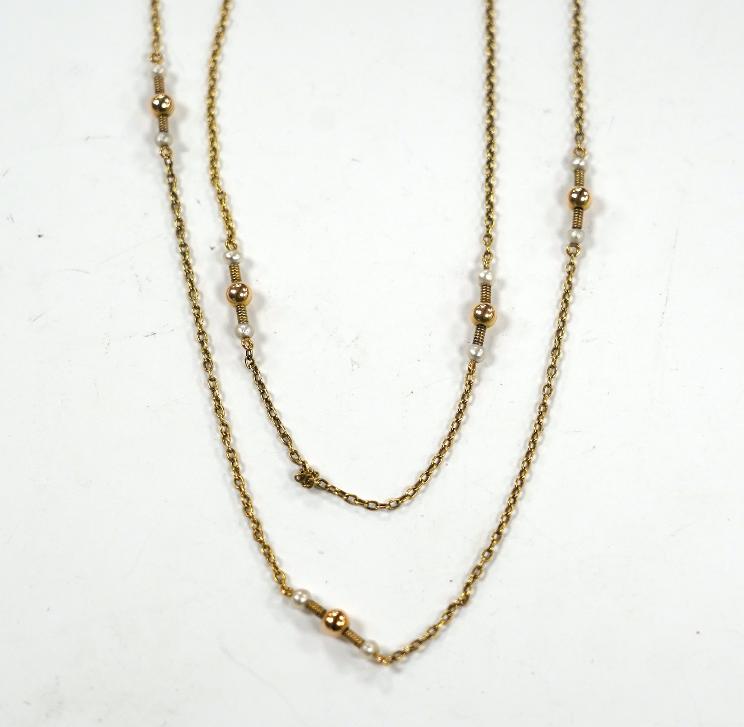 A 10k yellow metal and seed pearl set guard chain, 146cm, gross weight 14.2 grams.                                                                                                                                          