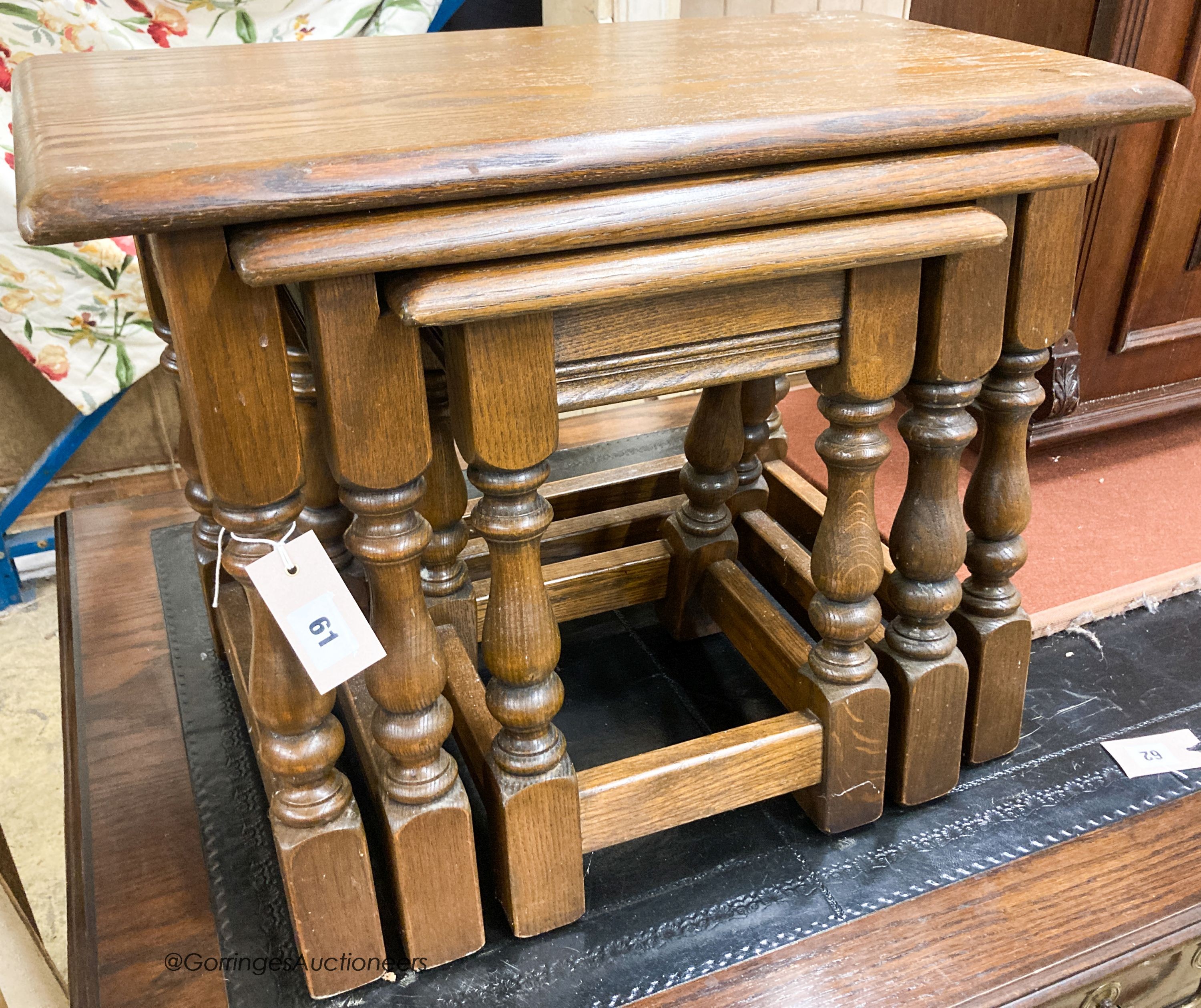 A nest of three reproduction rectangular oak tea tables, largest W.60cm W.32cm H.45cm                                                                                                                                       